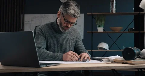 Portrait of Attractive Engineer making drawings with Pencil and ruler at his Stock Footage 126245118