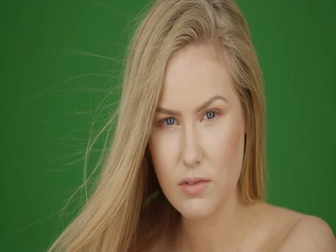 Portrait of attractive female model posing with bright windows on green screen Stock-Footage 79273321
