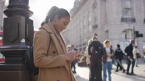 Portrait of attractive female using her phone and reacting with a laugh, in slow Stock Footage 252407267