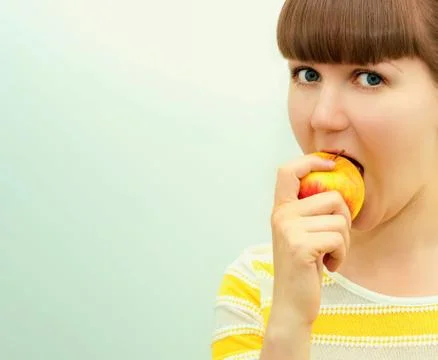 Portrait of attractive girl with apple Stock Photos