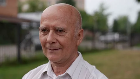 Portrait of an attractive handsome bald elderly man. Close-up portrait of a 動画素材 165199933