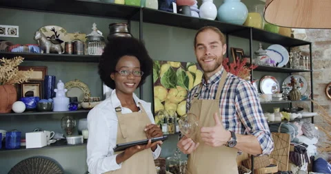 Portrait of attractive in high spirits smiling young mixed race sellers which Stock Footage 143967057