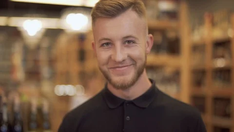 Portrait of attractive man drinking red wine. Smiling guy raises a wine glass Stock Footage 99373460