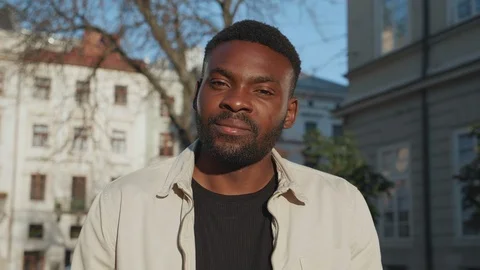 Portrait of Attractive Man Standing in front of Camera, starts to smile while Stock Footage 124465888