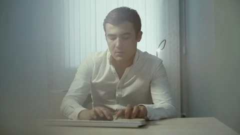 Portrait of attractive office worker typing on wireless keyboard in slow motion Stock Footage 111911228