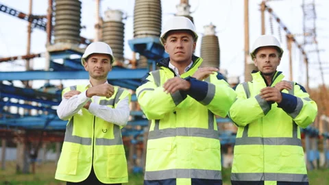 Portrait attractive three men engineers workers wearing safety uniform and hard Stock Footage 194624575