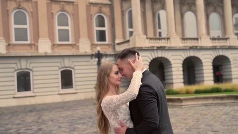 Portrait attractive wedding couple, in the central square of the old town  Stock Footage 129559070