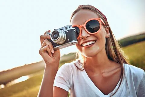 Portrait of attractive woman holding vintage camera Stock Photos