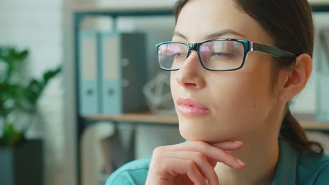 Portrait of a attractive young business woman in glasses smiling and posing on Stock Footage