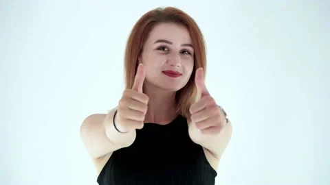 Portrait of attractive young gesturing double thumbs up. Studio shot Stock Footage 136014652