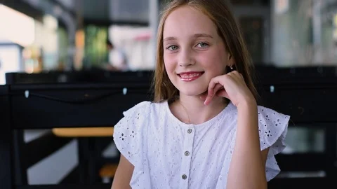 Portrait of attractive young girl looking forward at camera and smiling. Close Video stock 93306853