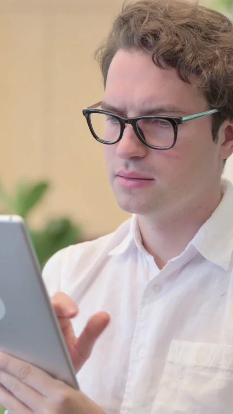 Portrait of Attractive Young Man Using Tablet in Modern Office, Vertical Video Stock Footage 340034058