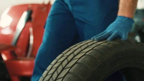 Portrait of automobile tire, when auto mechanic rilling of car tire on Stock Footage 76258611