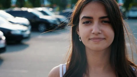 Portrait of awesome young lady with brunette hair smiling to the camera on the Видео 111489853