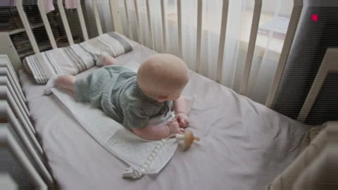 Portrait of Baby Practicing Tummy Time in Crib for Development Vídeos de archivo 346594561