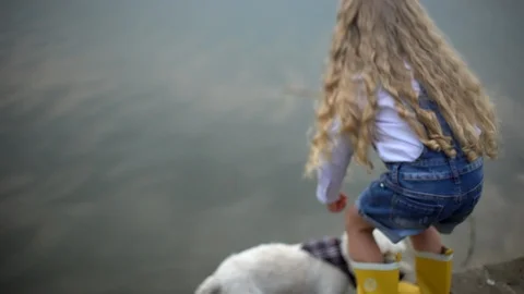 Portrait from back slow motion of blond girl 7-8 fishing and resting with small Stock Footage 91223097