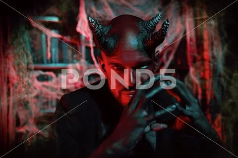 A portrait of a bad demon in his den. Horror movie, nightmare. Halloween. Stock Photos
