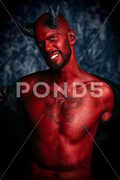 A portrait of a bad demon over the grunge background. Horror movie, nightmare Stock Photos