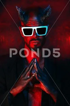 A portrait of a bad demon in sunglasses. Horror movie, nightmare. Halloween. Stock Photos