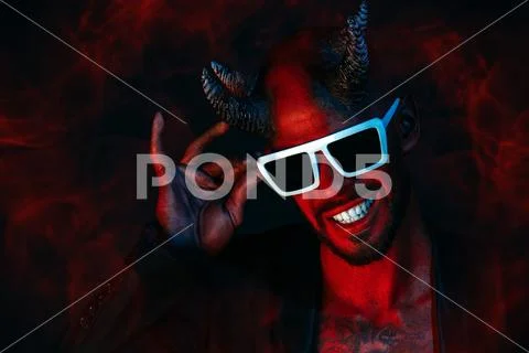 A portrait of a bad demon in sunglasses. Horror movie, nightmare. Halloween. Stock Photos