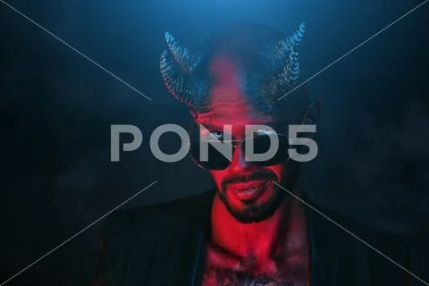 A portrait of a bad demon in sunglasses. Horror movie, nightmare. Halloween. Stock Photos