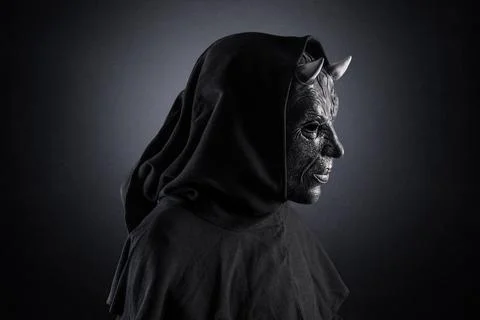 Portrait of a bad devil with horns on head over dark misty background Stock Photos