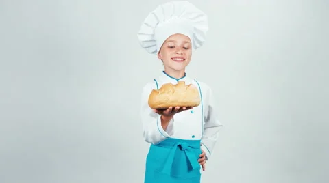 Portrait baker holds round bread in her hands and gives you smiling at camera Stock Footage