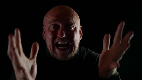Portrait of a bald man, an angry guy shouting directly into the camera. Male 動画素材 159528295