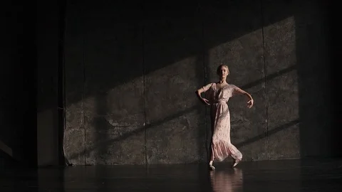 Portrait of a ballerina in pointes dancing classical ballet on a dark background Stock Footage 94036479