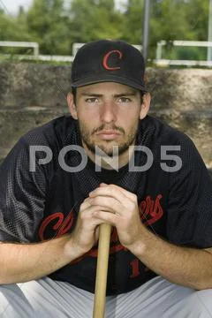 Portrait of a baseball player crouching with a baseball bat Stock Photos