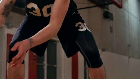 Portrait of of a basketball player doing tricks with a ball, pan up Stock Footage 70687658