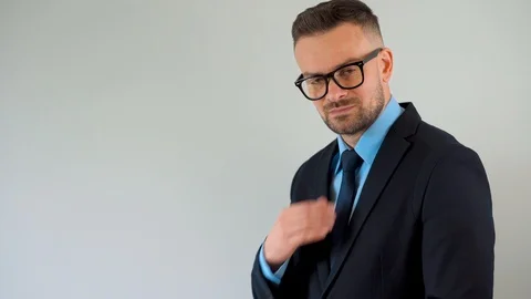 Portrait of a bearded formally dressed bearded man with glasses straightens his Stock Footage 119889525
