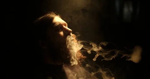 Portrait of bearded guy smoking vape and makes rings Stock Footage 88059535