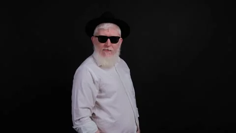 Portrait of bearded handsome young man with albnism that is posing over black Stock Footage 142215866