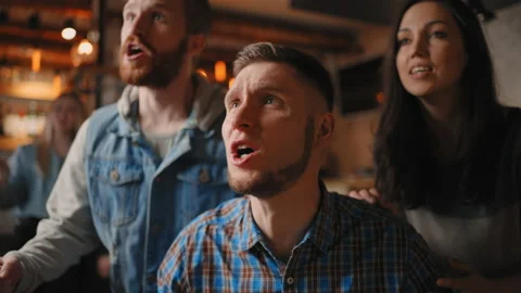 Portrait of a bearded male fan watching football in a bar with friends. World Stock Footage 187054853