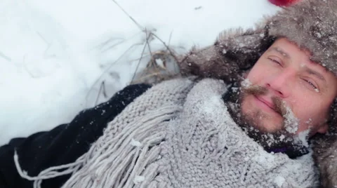 Portrait of a bearded man with an apple in the winter. Stock Footage 59602810