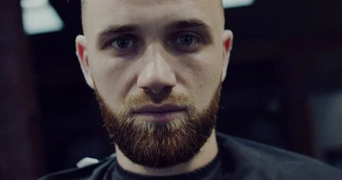 Portrait of a bearded man looking directly into the camera, filmed closely! Stock Footage 140043378