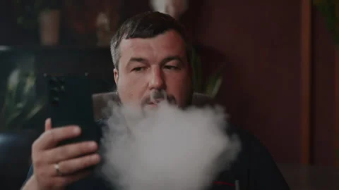 Portrait of a bearded man looking at a smartphone and translating his gaze Stock Footage 253411148
