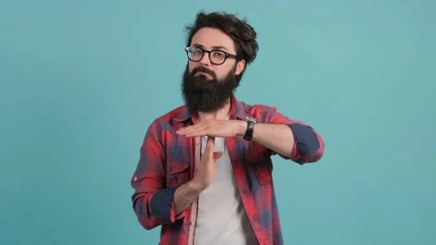Portrait of a bearded man making the time out gesture, asking for a break. Stock Footage 140117776
