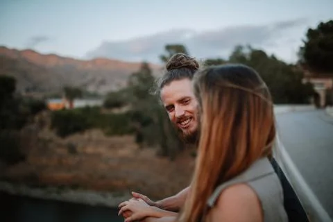 Portrait of bearded man smiling while look at her girlfriend in nature. Stock Photos