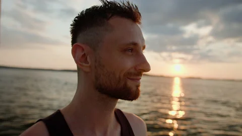 Portrait of a bearded man at sunset while walking on a yacht Stock Footage 235996785