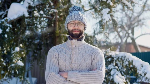 Portrait of a bearded man in a winter knitted hat with a pompom Stock Footage 101729335