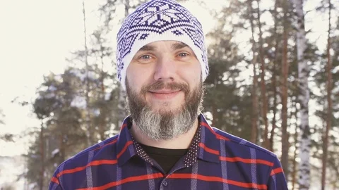 Portrait of a bearded smiling man in a winter forest Stock Footage 87204865