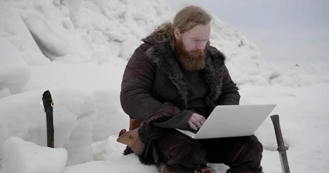 Portrait of bearded viking using laptop computer Stock Footage 106082021