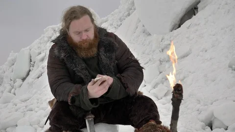 Portrait of bearded viking using mobile phone Stock Footage 106081955