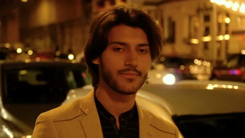 Portrait of a bearded young man on the background of the night city Video stock 112648665