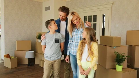 Portrait of beatiful caucasian family moving to the new stylish home smiling on Stock Footage