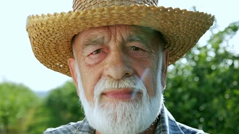 Portrait of a beautiful and happy old farmer with a beard Stock Footage