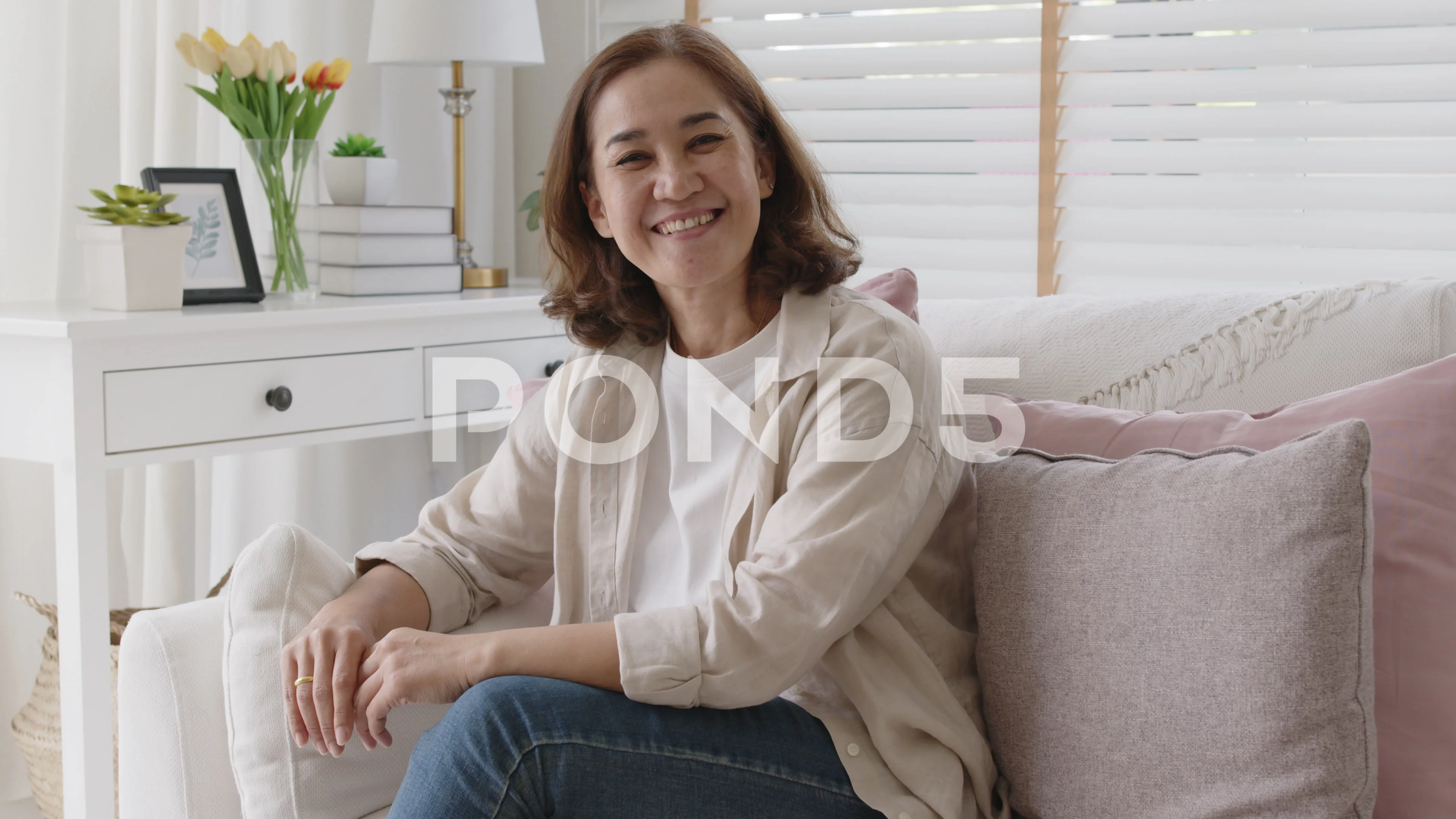 Portrait beautiful asian senior mature middle-aged woman at home sofa.