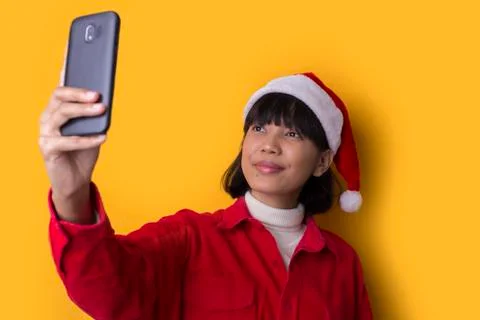 Portrait beautiful asian women wear santa christmas hat taking selfie Stock Photos